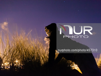 A migrant looks out for police presence near the port from behind some bushes. Calais, France, June 2014.

For the last 20 years the Frenc...