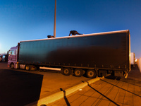 Migrants on top of a truck try to access the container by cutting a hole on the lining. Calais, France, June 2014.

For the last 20 years...