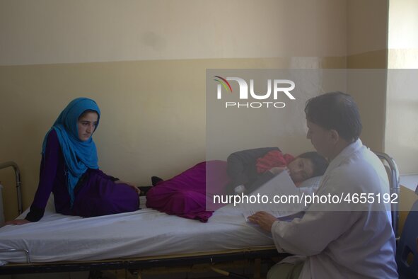 Afghan schoolgirls receive medical treatment at a local hospital after being admitted for symptoms of poisoning, in Badakhshan, Afghanistan,...