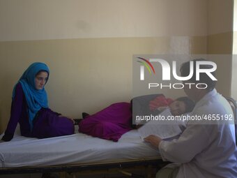 Afghan schoolgirls receive medical treatment at a local hospital after being admitted for symptoms of poisoning, in Badakhshan, Afghanistan,...