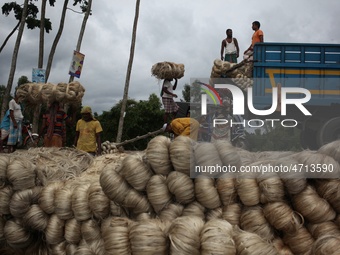 Labourers carry jute from a boat to a truck to send it in the capital Dhaka. Photo has taken on 26 July 2019 from Kurigram, Bangladesh.  (