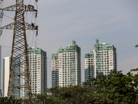 Operators work on a high voltage tower in Jakarta, Indonesia, July 27, 2019.  (