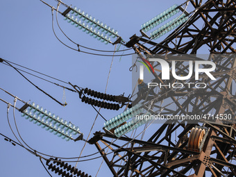 Operators work on a high voltage tower in Jakarta, Indonesia, July 27, 2019.  (