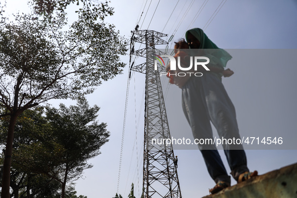 Operators work on a high voltage tower in Jakarta, Indonesia, July 27, 2019.  