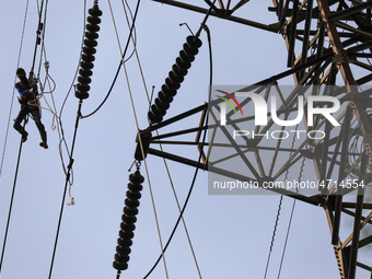 Operators work on high voltage power lines in Jakarta, Indonesia, July 27, 2019.  (