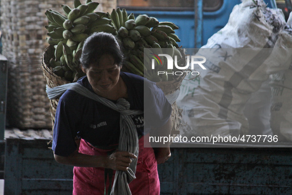 Female freight workers serve customers in Beringharjo traditional market, Special Region of Yogyakarta province, on Monday, August 5, 2019....