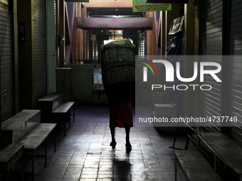 Female freight workers serve customers in Beringharjo traditional market, Special Region of Yogyakarta province, on Monday, August 5, 2019....