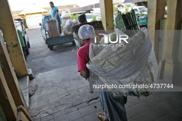 Female freight workers serve customers in Beringharjo traditional market, Special Region of Yogyakarta province, on Monday, August 5, 2019....