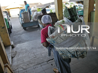 Female freight workers serve customers in Beringharjo traditional market, Special Region of Yogyakarta province, on Monday, August 5, 2019....