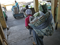 Female freight workers serve customers in Beringharjo traditional market, Special Region of Yogyakarta province, on Monday, August 5, 2019....