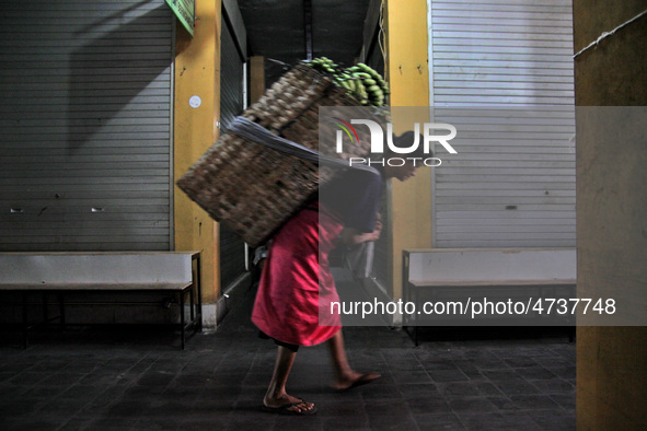 Female freight workers serve customers in Beringharjo traditional market, Special Region of Yogyakarta province, on Monday, August 5, 2019....