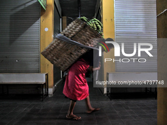 Female freight workers serve customers in Beringharjo traditional market, Special Region of Yogyakarta province, on Monday, August 5, 2019....