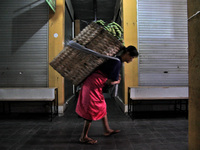 Female freight workers serve customers in Beringharjo traditional market, Special Region of Yogyakarta province, on Monday, August 5, 2019....