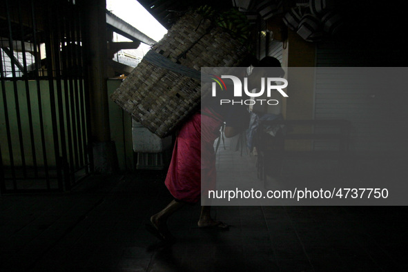 Female freight workers serve customers in Beringharjo traditional market, Special Region of Yogyakarta province, on Monday, August 5, 2019....