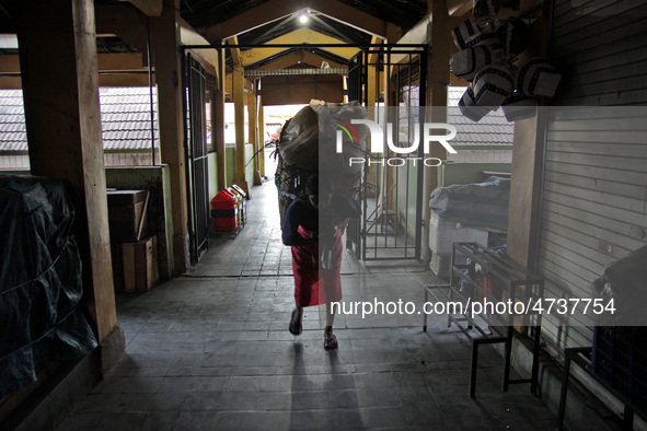 Female freight workers serve customers in Beringharjo traditional market, Special Region of Yogyakarta province, on Monday, August 5, 2019....