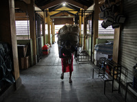 Female freight workers serve customers in Beringharjo traditional market, Special Region of Yogyakarta province, on Monday, August 5, 2019....