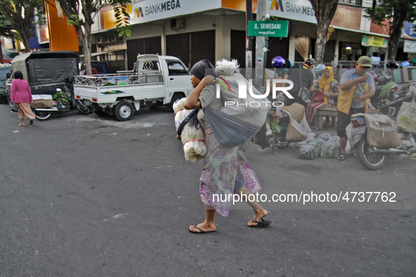 Female freight workers serve customers in Beringharjo traditional market, Special Region of Yogyakarta province, on Monday, August 5, 2019....