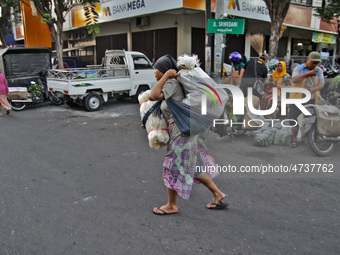 Female freight workers serve customers in Beringharjo traditional market, Special Region of Yogyakarta province, on Monday, August 5, 2019....