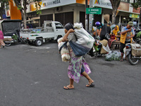 Female freight workers serve customers in Beringharjo traditional market, Special Region of Yogyakarta province, on Monday, August 5, 2019....