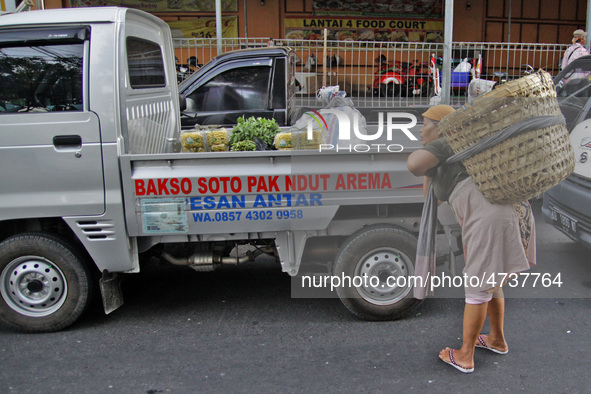 Female freight workers serve customers in Beringharjo traditional market, Special Region of Yogyakarta province, on Monday, August 5, 2019....