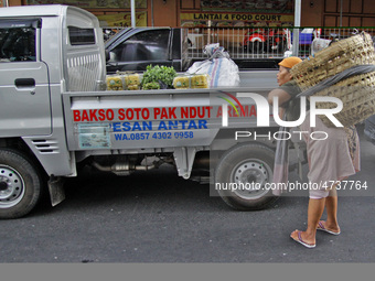 Female freight workers serve customers in Beringharjo traditional market, Special Region of Yogyakarta province, on Monday, August 5, 2019....