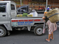 Female freight workers serve customers in Beringharjo traditional market, Special Region of Yogyakarta province, on Monday, August 5, 2019....