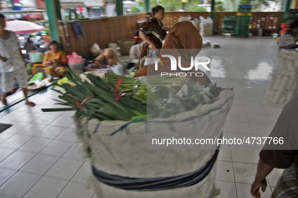 Female freight workers serve customers in Beringharjo traditional market, Special Region of Yogyakarta province, on Monday, August 5, 2019....