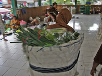 Female freight workers serve customers in Beringharjo traditional market, Special Region of Yogyakarta province, on Monday, August 5, 2019....