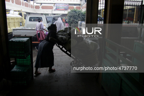 Female freight workers serve customers in Beringharjo traditional market, Special Region of Yogyakarta province, on Monday, August 5, 2019....