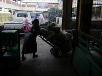 Female freight workers serve customers in Beringharjo traditional market, Special Region of Yogyakarta province, on Monday, August 5, 2019....