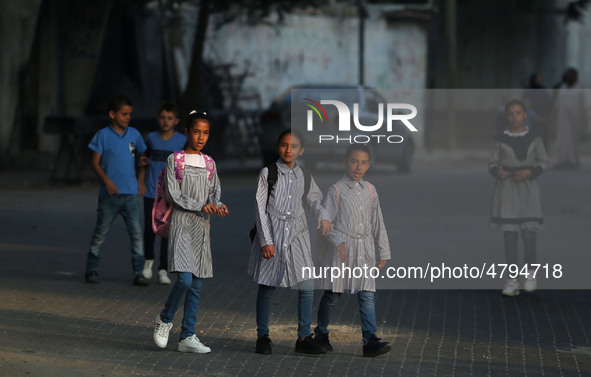 Palestinian students walk on their way at a United Nations-run school, on the first day of a new school year, in Gaza City on August 25, 201...