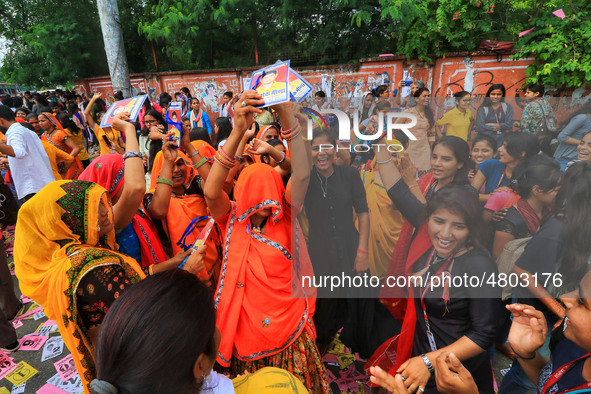 Family members and supporters of the candidates dance during the Rajasthan University Students Union (RUSU) election polling, outside Mahara...