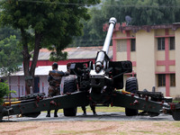 Indian school students take a close look at the various defence equipment during an exhibition organised by the Indian Army in Ajmer, Rajast...