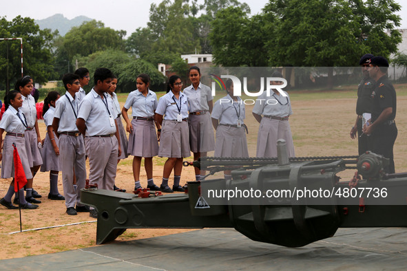 Indian school students take a close look at the various defence equipment during an exhibition organised by the Indian Army in Ajmer, Rajast...