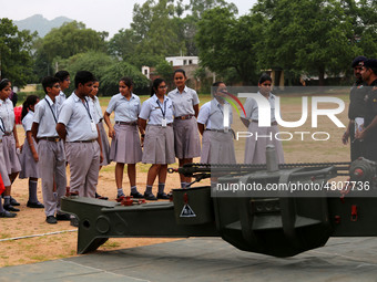 Indian school students take a close look at the various defence equipment during an exhibition organised by the Indian Army in Ajmer, Rajast...