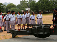 Indian school students take a close look at the various defence equipment during an exhibition organised by the Indian Army in Ajmer, Rajast...