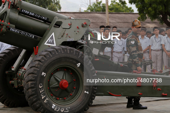 Indian school students take a close look at the various defence equipment during an exhibition organised by the Indian Army in Ajmer, Rajast...