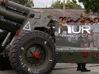 Indian school students take a close look at the various defence equipment during an exhibition organised by the Indian Army in Ajmer, Rajast...