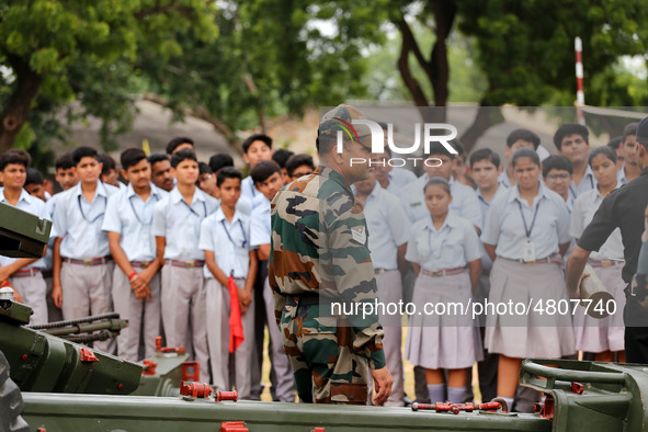 Indian school students take a close look at the various defence equipment during an exhibition organised by the Indian Army in Ajmer, Rajast...