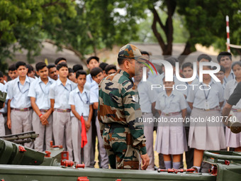 Indian school students take a close look at the various defence equipment during an exhibition organised by the Indian Army in Ajmer, Rajast...