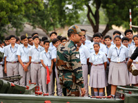 Indian school students take a close look at the various defence equipment during an exhibition organised by the Indian Army in Ajmer, Rajast...