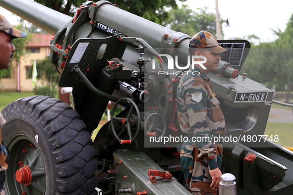 Indian school students take a close look at the various defence equipment during an exhibition organised by the Indian Army in Ajmer, Rajast...