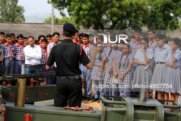 Indian school students take a close look at the various defence equipment during an exhibition organised by the Indian Army in Ajmer, Rajast...