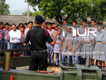 Indian school students take a close look at the various defence equipment during an exhibition organised by the Indian Army in Ajmer, Rajast...