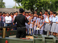 Indian school students take a close look at the various defence equipment during an exhibition organised by the Indian Army in Ajmer, Rajast...