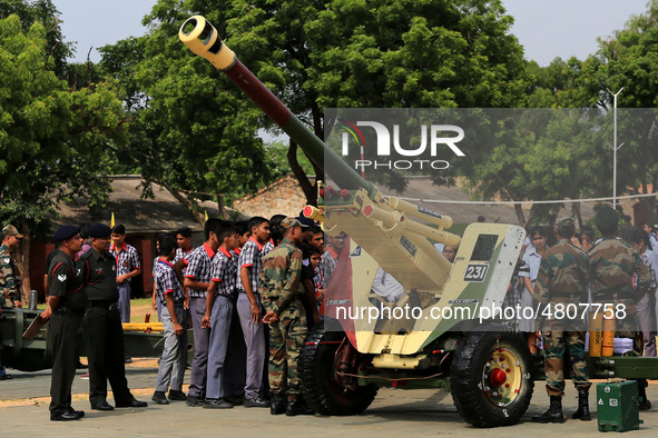 Indian school students take a close look at the various defence equipment during an exhibition organised by the Indian Army in Ajmer, Rajast...