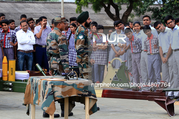 Indian school students take a close look at the various defence equipment during an exhibition organised by the Indian Army in Ajmer, Rajast...