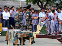 Indian school students take a close look at the various defence equipment during an exhibition organised by the Indian Army in Ajmer, Rajast...