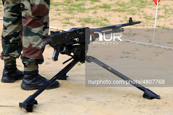 Indian school students take a close look at the various defence equipment during an exhibition organised by the Indian Army in Ajmer, Rajast...