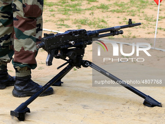 Indian school students take a close look at the various defence equipment during an exhibition organised by the Indian Army in Ajmer, Rajast...